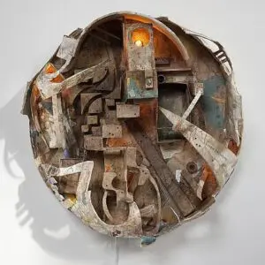 Abstract circular sculpture with layered mixed media.