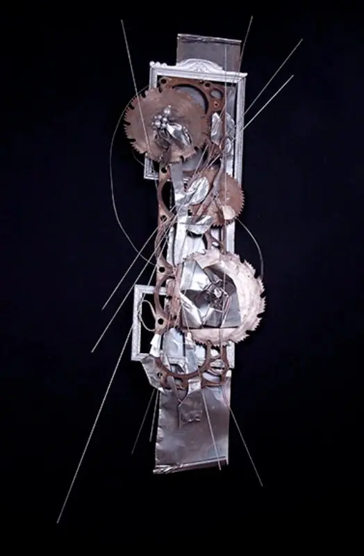 Abstract metal sculpture with gears and wires.