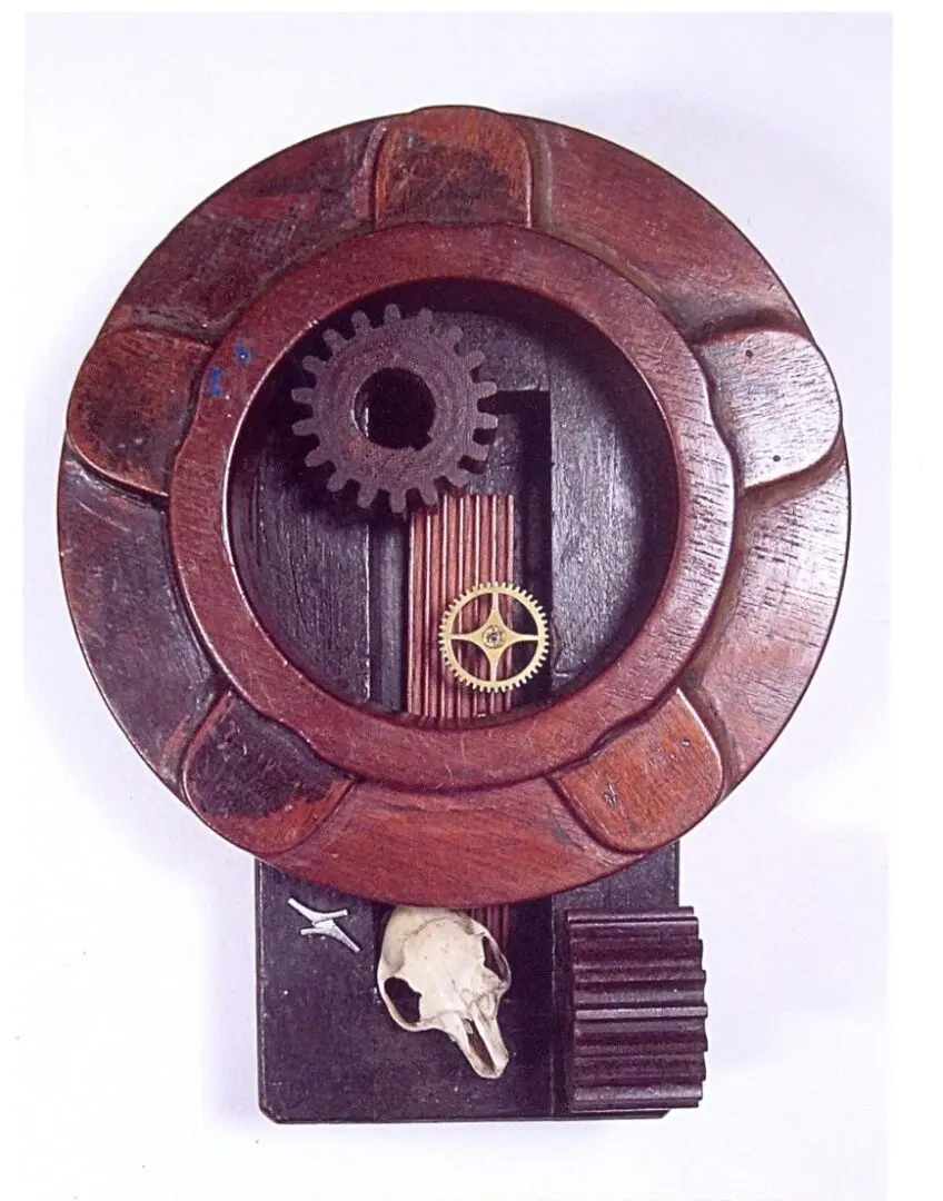 Wooden assemblage with gears and animal skull.