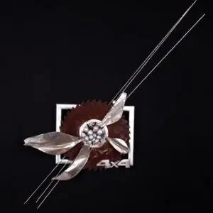 Four silver wires intersecting floral saw blade sculpture
