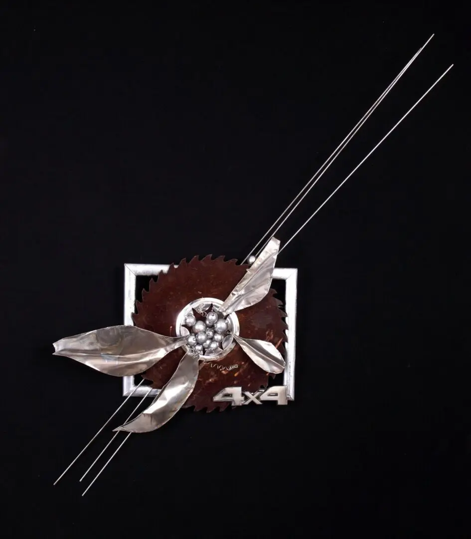 Four silver wires intersecting floral saw blade sculpture