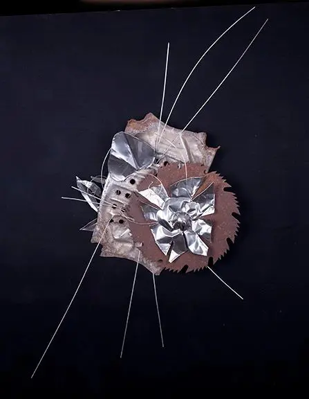 Abstract metal and wire art on black.