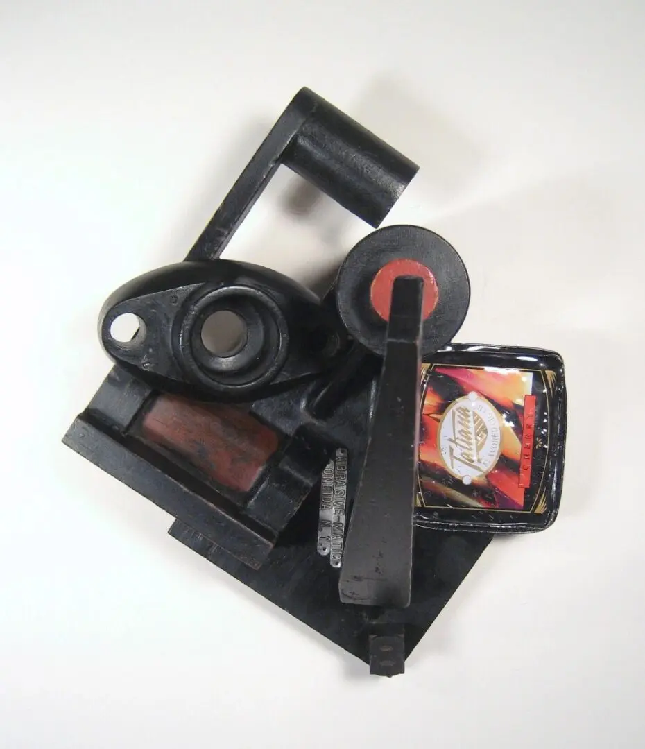 Abstract sculpture with industrial and colorful elements.