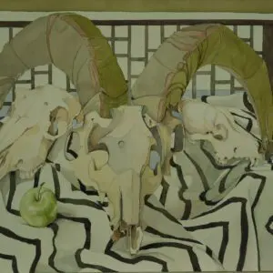 Ram skulls with green apple on fabric.