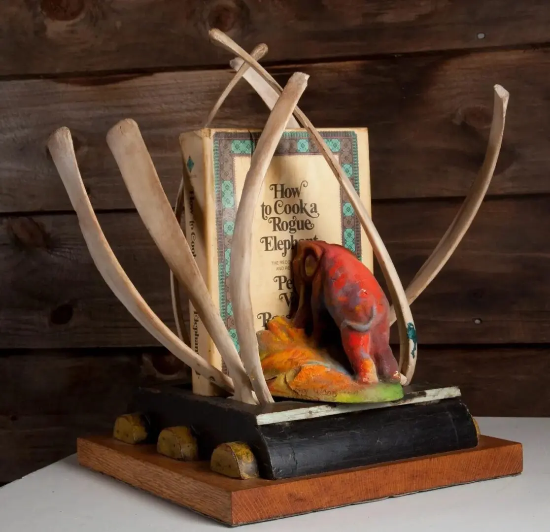 Book sculpture with elephant and tusks.