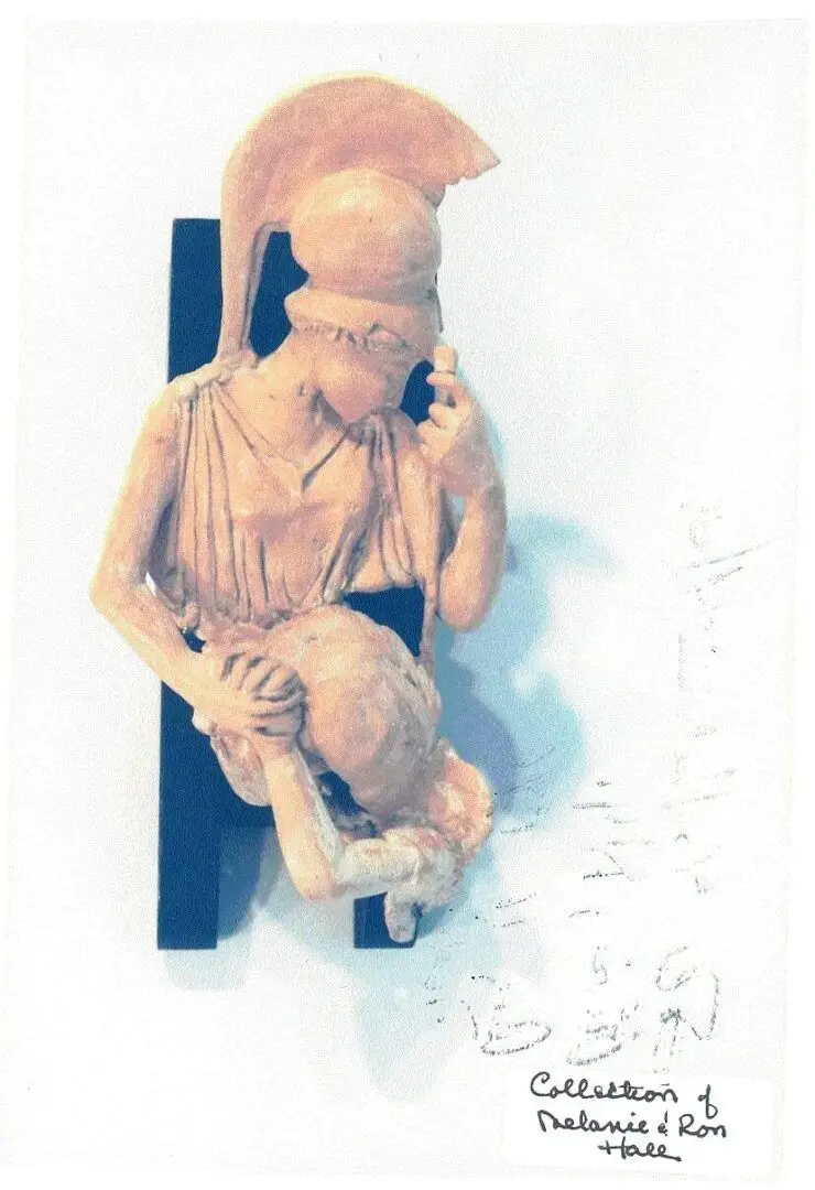 Ancient warrior statue with helmet and shield.