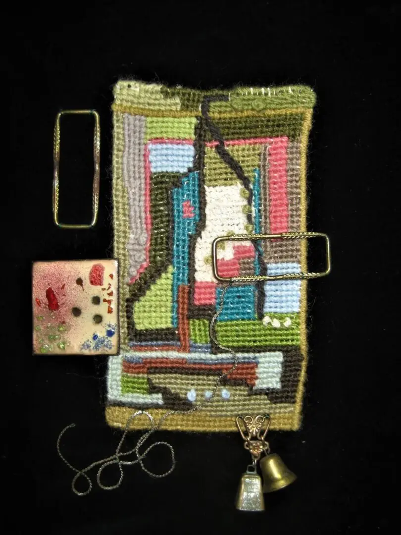 Abstract textile art with bells and beads.