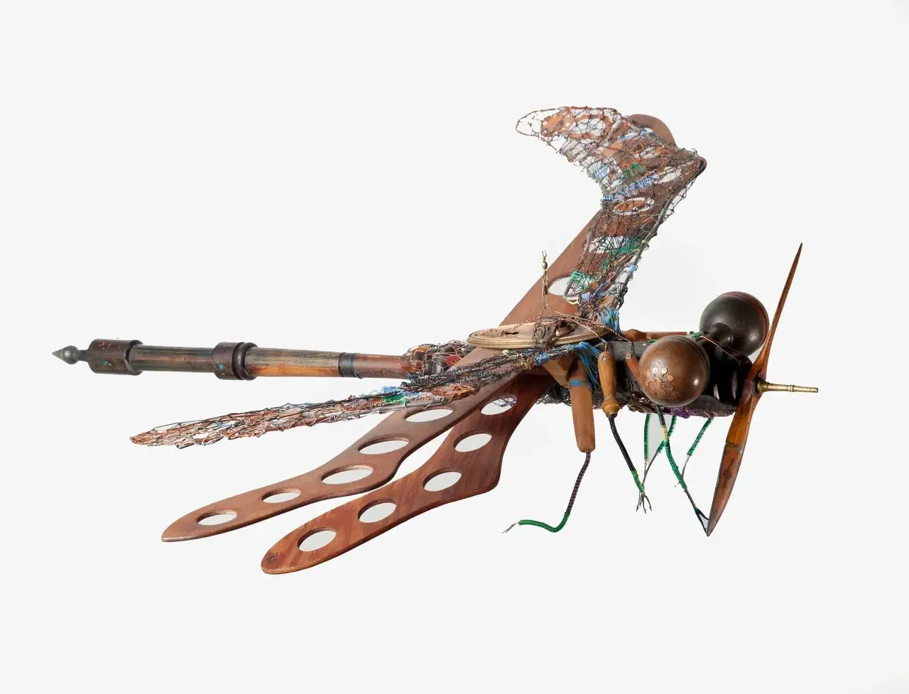 Sculpture of dragonfly made from various materials.