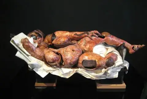 Abstract sculpture of a reclining humanoid figure.