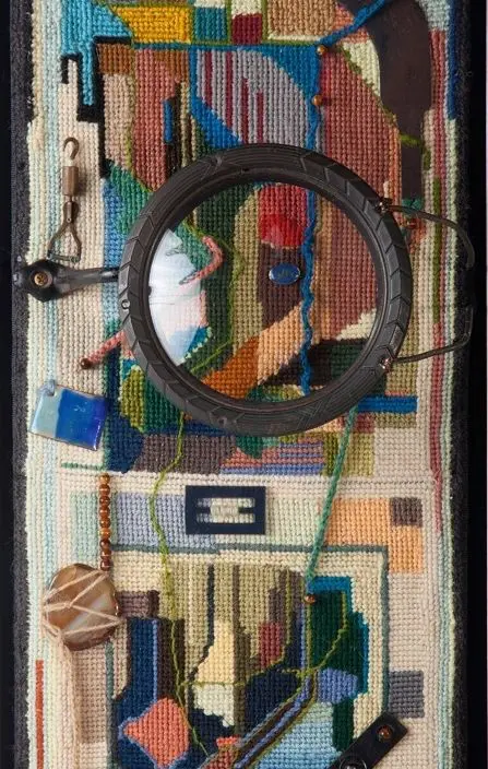 Abstract textile art with circular element.