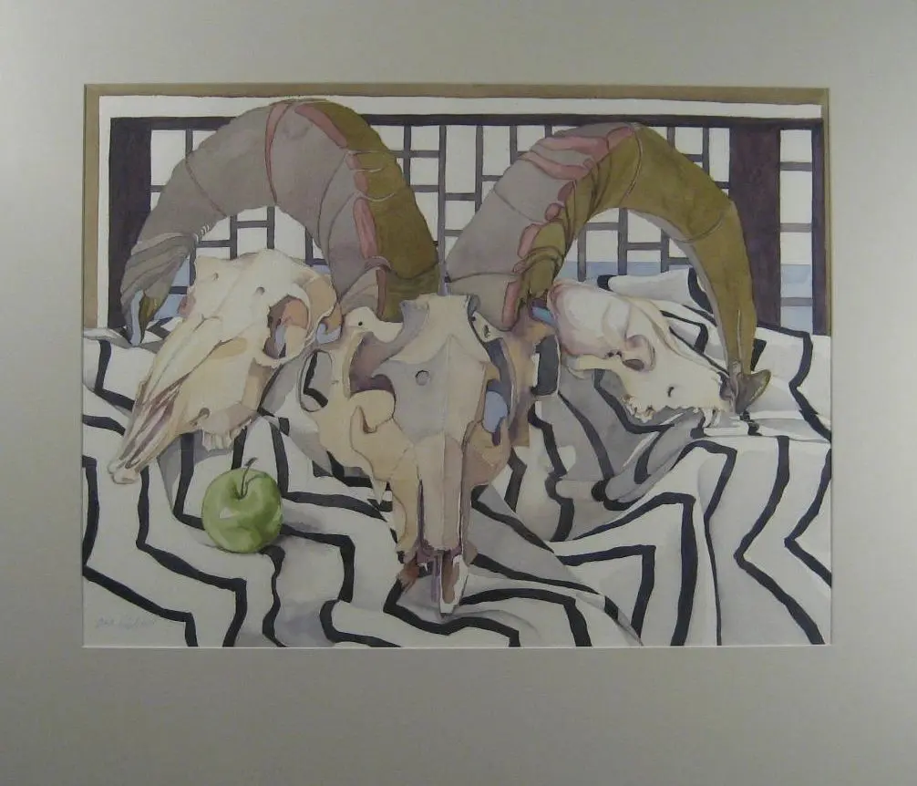 Ram skulls with apple on patterned cloth.