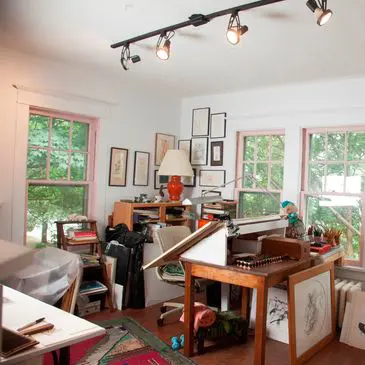 Art studio with drawing table and supplies.