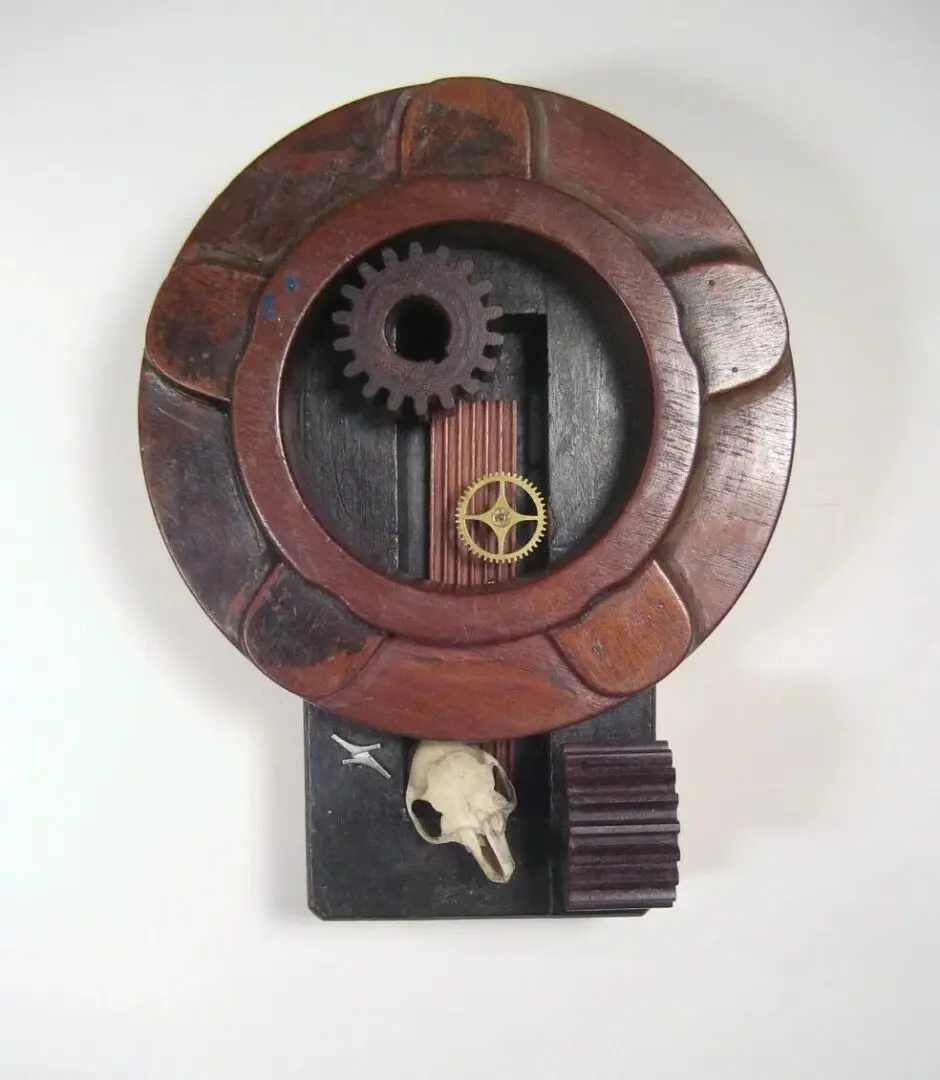 Wooden art piece with gears and skull.