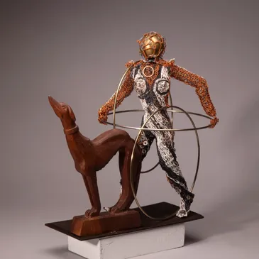 Diver sculpture with dog and hoops.