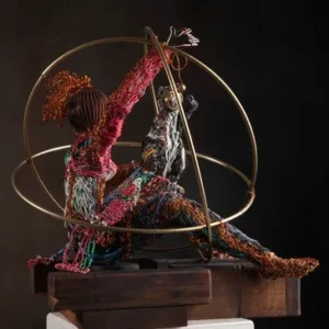 Wire sculpture reclining surrounded by circular metal hoops