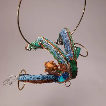 Colorful abstract sculpture with circular metal elements.